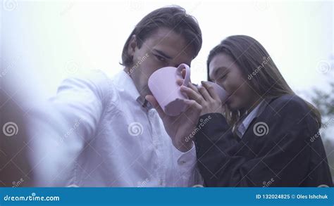 Happy Smilling Couple Is Doing Selfie Drinking Coffee Outdoors Guy With Girlfriend Spending Time
