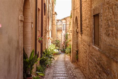 Beautiful View Of An Alley With Stone Buildings In Spello Italy Stock