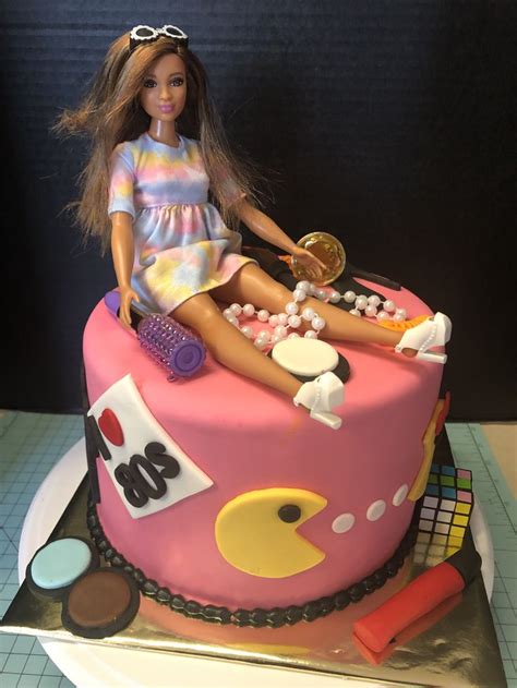 A Barbie Doll Sitting On Top Of A Pink Cake