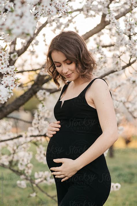 Sensual Pregnant Woman In Blooming Garden By Stocksy Contributor