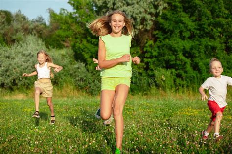 Kids Children Running On Meadow In Summer S Sunlight Stock Image