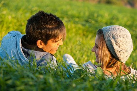 Couple Laying In Grass Field At Sunset Stock Photo Image 28280954