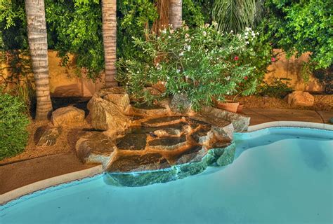 Desert Oasis With Sparkling Pool And Rock Waterfall Scottsdale Arizona