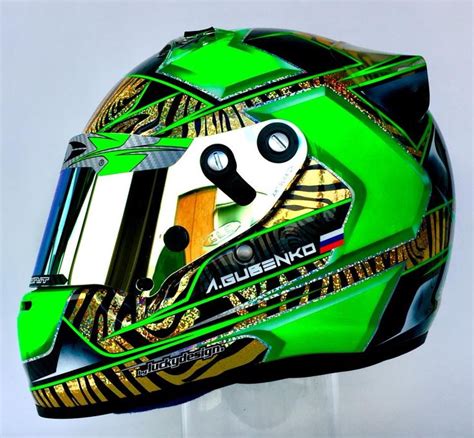 The Helmet Is Designed To Look Like A Race Car Drivers Face With Gold
