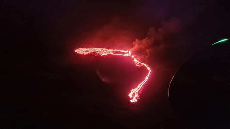 Reykjaviks Night Sky Lights Up As Volcano In