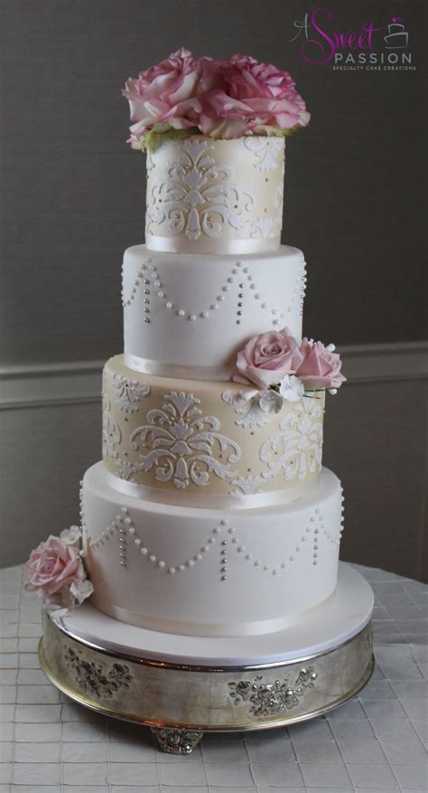 this elegant wedding cake shimmers for a couple s special day damask pearl draping and real