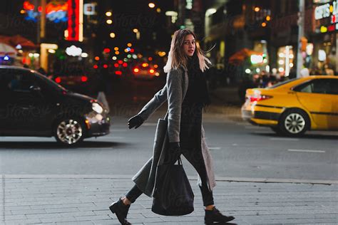 Young Woman Walking In The City At Night By Stocksy Contributor