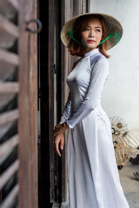 Vietnamese Woman In White Ao Dai Traditional Costume And Conical Hat