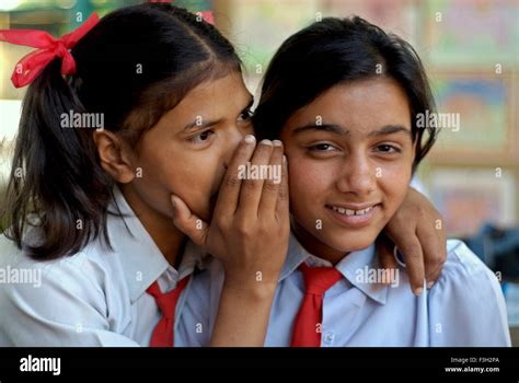 One Girl Whispering Into Another Girls Ear At Nanhi Dunya Dehradun
