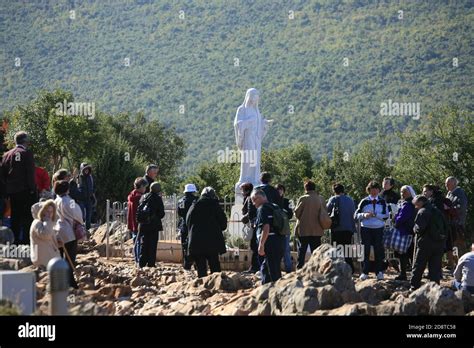Our Lady Of Medjugorje Pilgrims Praying Bye The Virgin Mary Statue On
