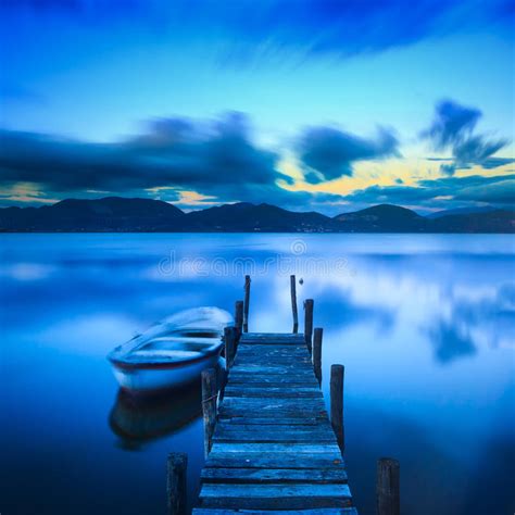 Wooden Pier Or Jetty And A Boat On A Lake Sunset Versilia Tusca Stock