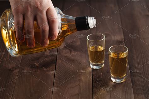 Pouring Alcohol In Shot Glass High Quality Stock Photos Creative Market