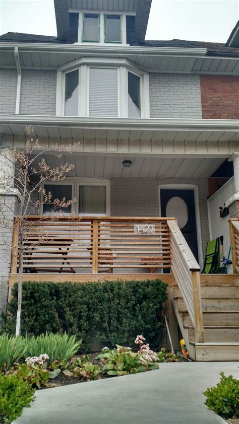 A horizontal slat fence, railing and privacy walls around patio. Front porch railing, horizontal slats - Modern | Front ...