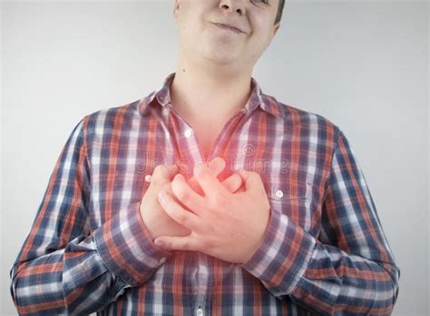 A Man Grabs His Chest In The Region Of The Heart Heart Attack Or Chest Pain The Concept Of
