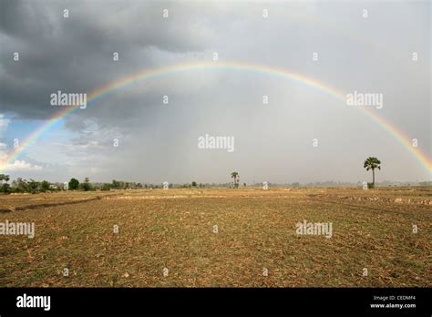 Rainbow Over Field Stock Photo Alamy