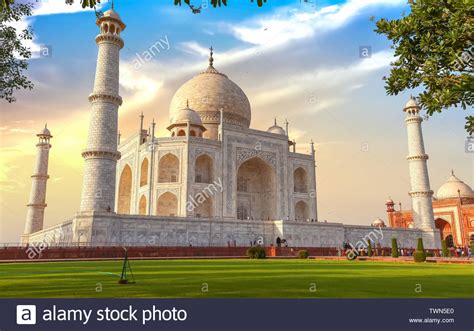 Taj Mahal Historic Marble Mausoleum At Sunset With View Of Tourists