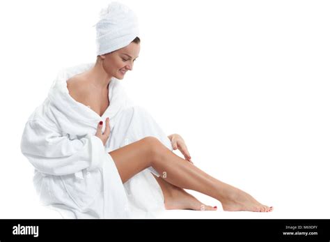 Beautiful Girl In Bathrobe Is Touching Her Smooth Legs Spa Depilation And Bodycare Concept
