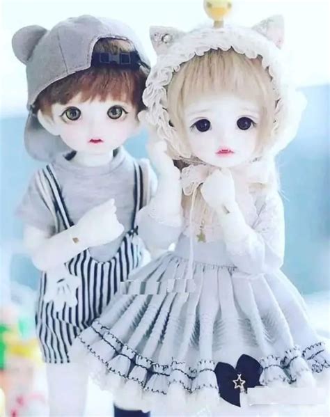 Two Dolls Are Dressed In Clothes And Hats