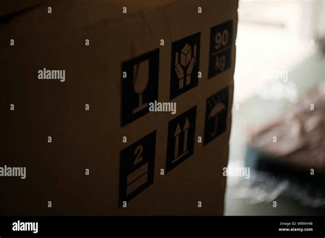 Cardboard Box With Warning Stickers Stock Photo Alamy
