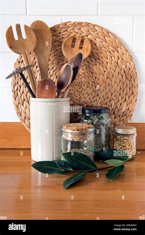 Eco Friendly Kitchen Utensils With Recycled Glass Storage Jars Against White Tiles And Bay