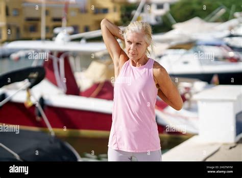 Mature Sportswoman Stretching Her Arms After Exercise Stock Photo Alamy