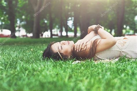 夏の公園の草の上に横たわる美しい少女 — ストック写真 © Milkos 118465070