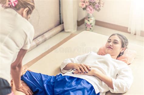 Woman Is Getting Leg Massage In Spa While Lying On A Spa Bed Stock