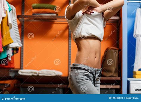 Young Woman Take Off Her T Shirt In Wardrobe Stock Image Image Of