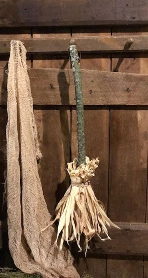 A Piece Of Cloth Hanging On A Wooden Wall Next To An Old Door With A Plant In It