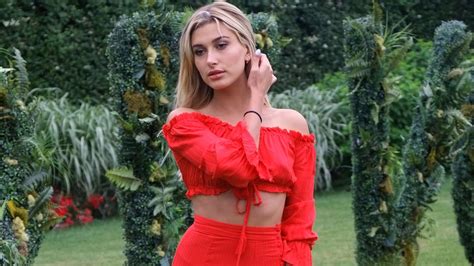 hailey baldwin wears a red two piece to the revolve hamptons summer party teen vogue