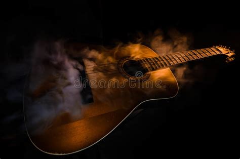 Music Concept Acoustic Guitar On A Dark Background Under