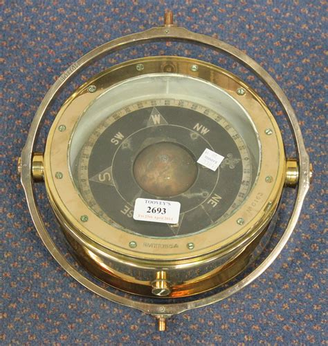 A Brass Cased Ships Compass With Gimbal Mount And Ministry Of Defence