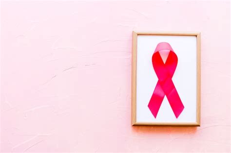 Free Photo Wooden White Frame With Breast Cancer Awareness Pink Ribbon