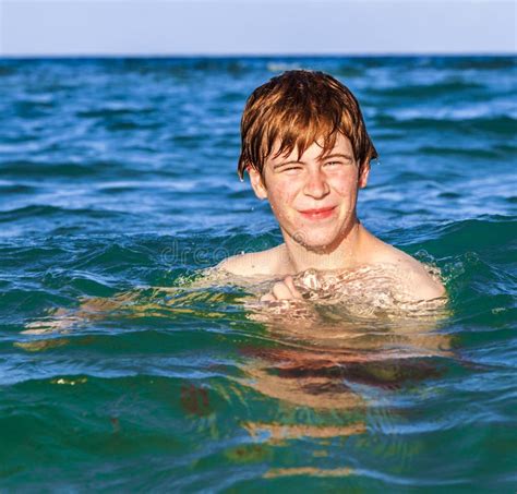 Smiling Teen Boy Swimming In The Ocean Stock Photo Image Of Confident