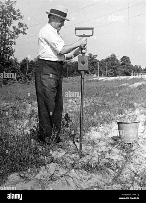 Worker Performing A Moisture Test On Soil At The United States