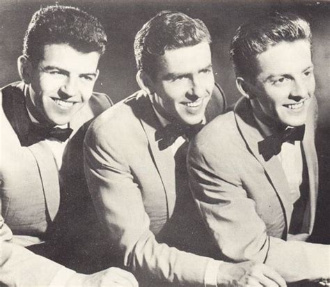 Three Men In Suits And Bow Ties Posing For The Camera