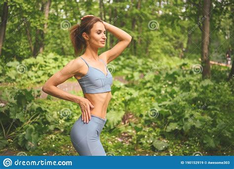 beautiful fit woman in in sportswear muscular slim attractive female with flat belly in summer