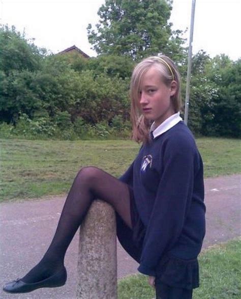 Schoolgirl In Navy School Uniform Leg Up Over Fence Post In