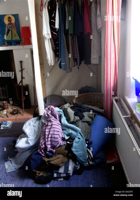 Messy Piles Of Clothes In Teenage Boys Bedroom Stock Photo Alamy