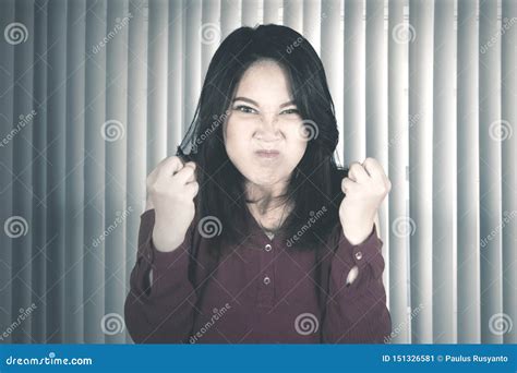 angry woman clenches her fists near the window stock image image of gritting japanese 151326581