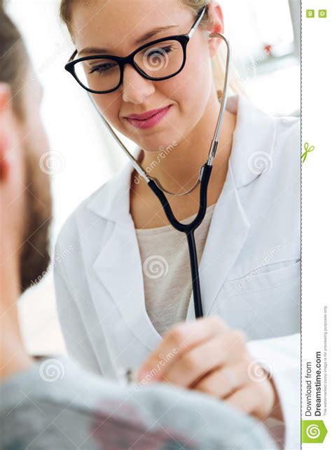 Female Doctor Checking Patient Heartbeat Using Stethoscope Stock Image