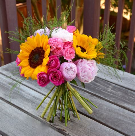 A Pretty Sunshine Bouquet With Sunflowers Peonies Roses And