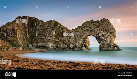 Durdle Door At Sunset Natural Limestone Arch On Jurassic Coastline Of