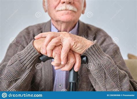 Elderly Man Sitting With Crutch Stock Photo Image Of Lifestyles