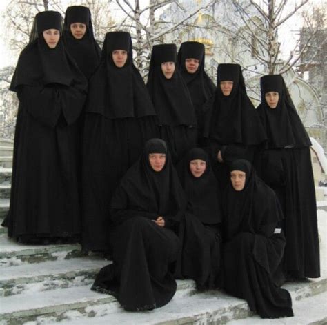 A Group Of Women Dressed In Black Sitting On Steps