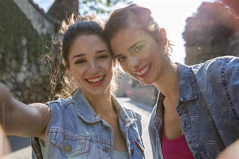 Two Happy Girlfriends Taking A Selfie Outdoors On Sunny Summer Day By Jovo Jovanovic Stocksy