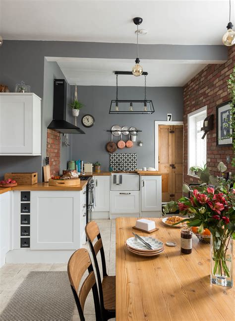 For subtle contrast, two different shades of the same calm colour tend to work better on cabinetry than three or four, which can look like a design mistake. shaker style kitchen with grey walls, a wooden dining ...