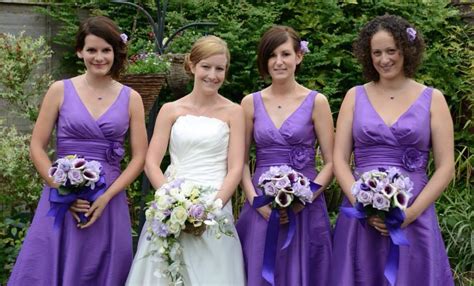 Four Bridesmaids In Purple Dresses Posing For The Camera