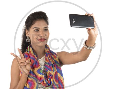 Image Of An Young Indian Girl Taking Selfie With Smart Phone And