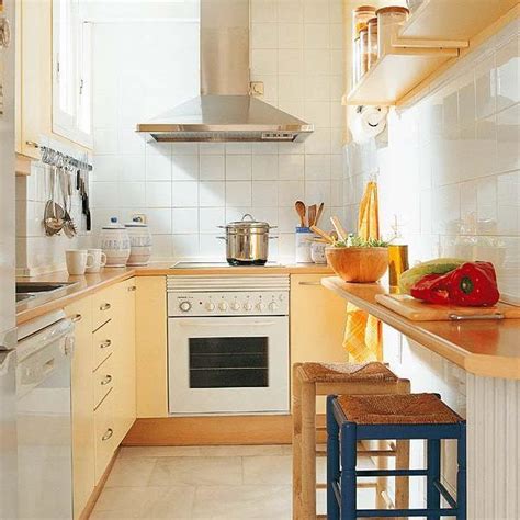 In the kitchen, the island has a top of honed carrara marble, the wall tiles are by waterworks, the stove is viking, and the stools are by york street studio; Small Kitchens and Space Saving Ideas to Create Ergonomic Modern Kitchen Design